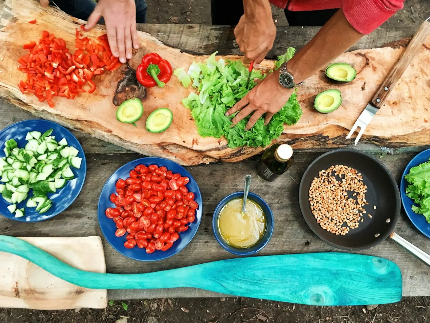 Hands chopping peppers, cucumbers and lettuce for the week ahead