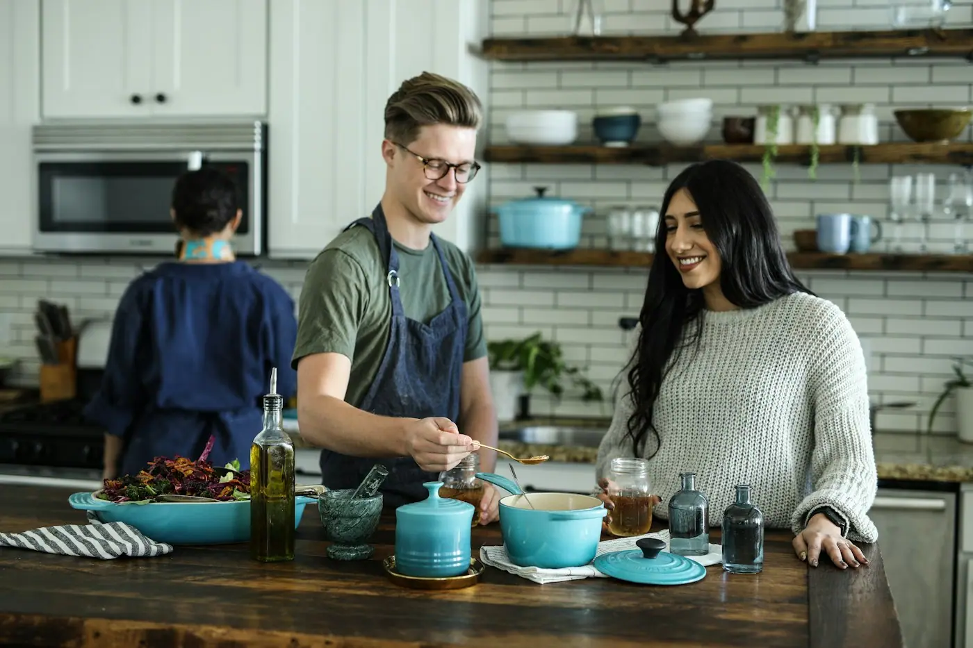 A family cooking dinner together in a bright kitchen